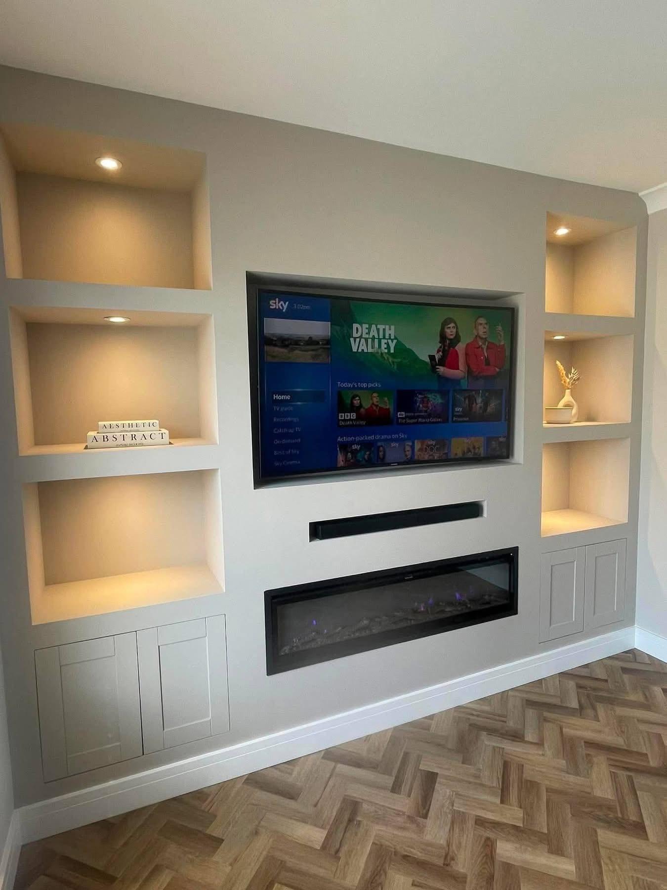 Media wall with warm recessed display lighting, TV and electric fire installed by Morlec Electrical