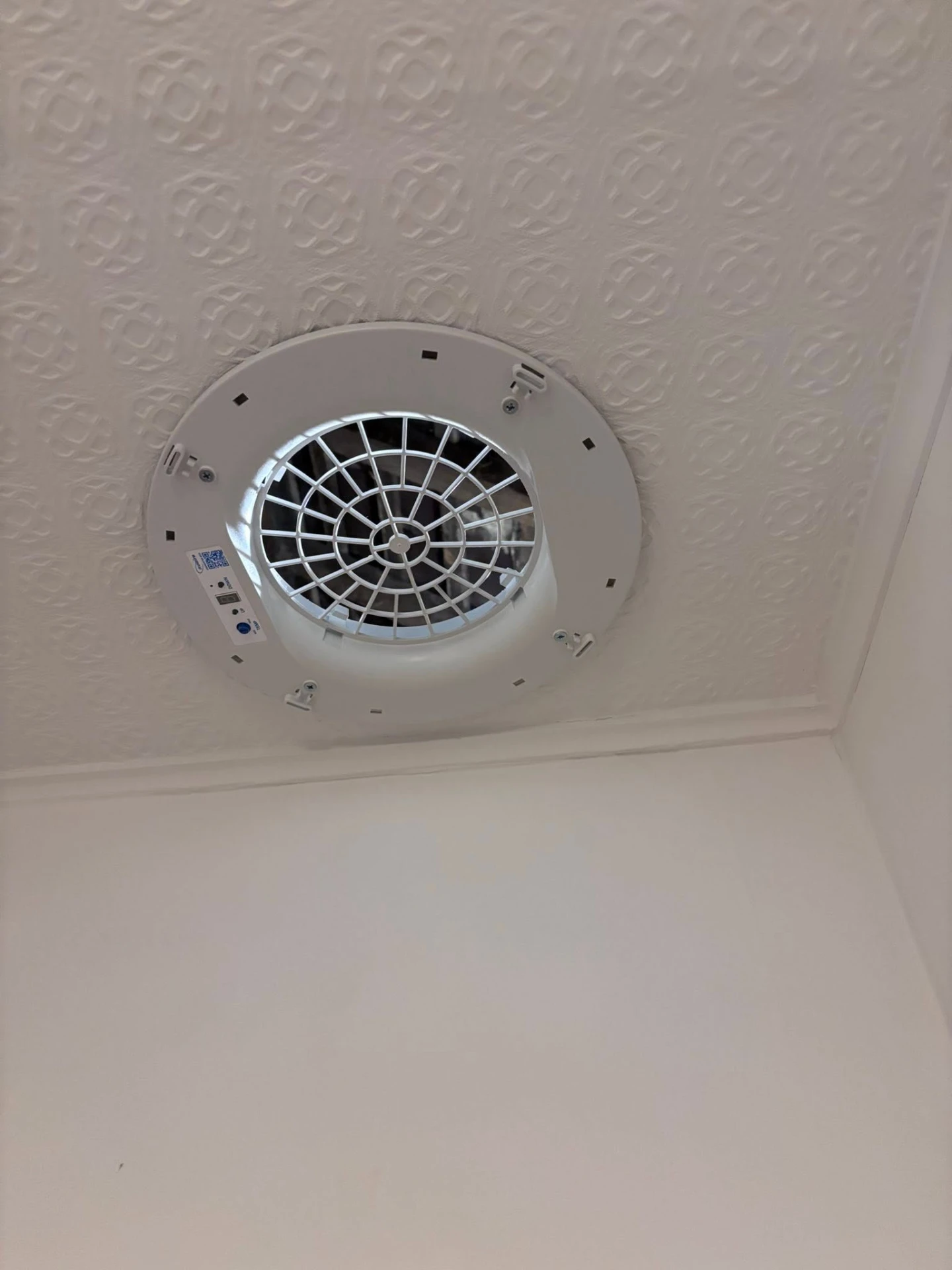 Ceiling-mounted extractor fan installed in a bathroom, electrical work by Morlec Electrical in Pembrokeshire